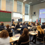 A group of participants with professors in the auditorium